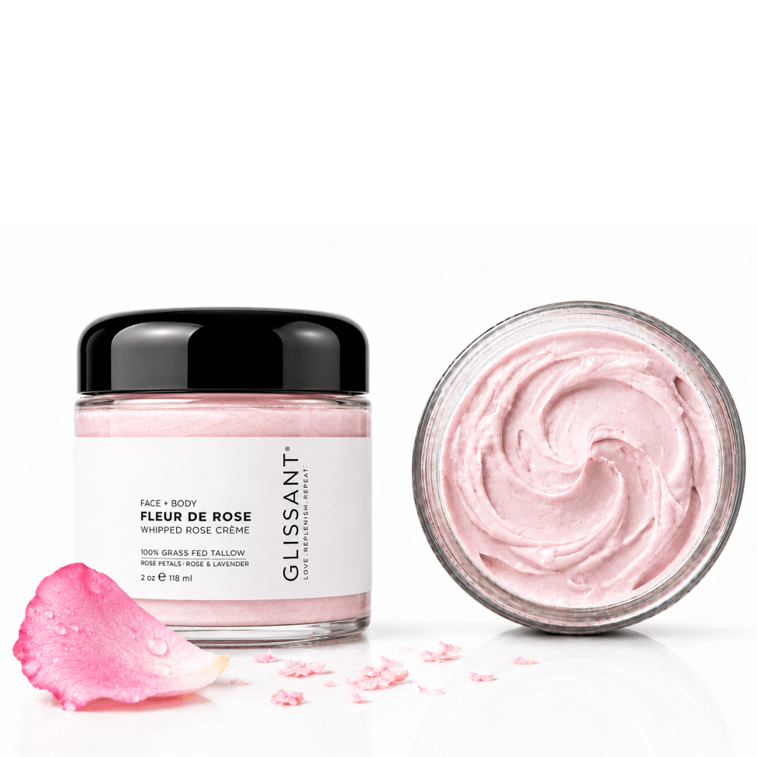 A jar of Glissant Fleur de Rose Face + Body Wapped Rose Crème shown next to an open jar displaying the pink whipped cream texture, with a pink rose petal on a clean white background.